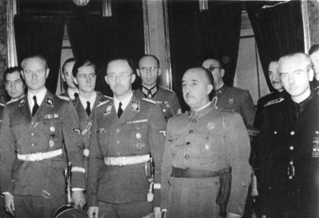 1940: SS Commander and leading Nazi, Heinrich Himmler (centre  left)  next to Fransisco Franco in Madrid.