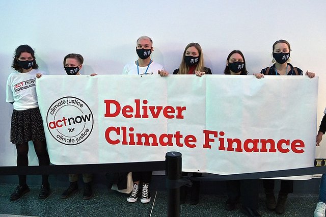 COP26 activists demand climate justice photo by Dean Calma/IAEA